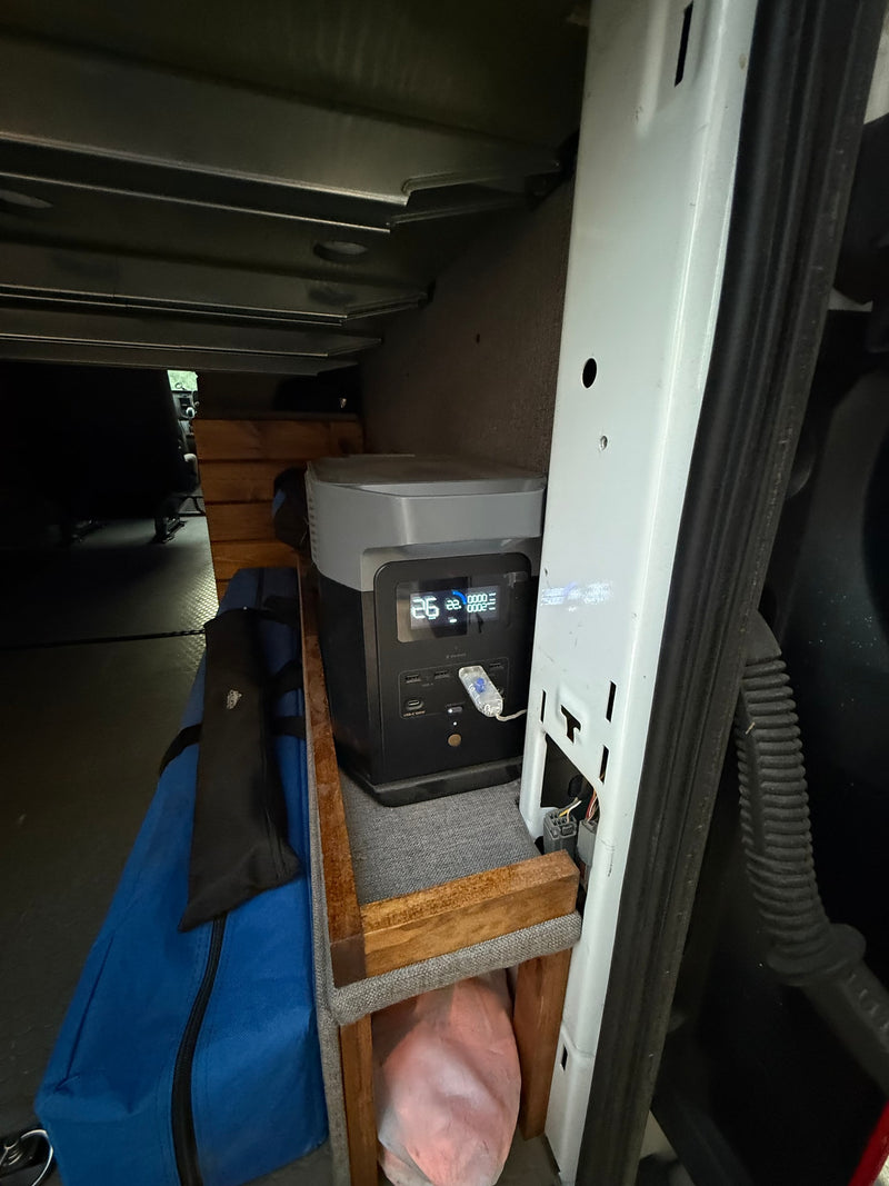  parked in fresh snow with tire tracks and footprints.|Spacious rv rental camper van with open rear doors — photo 6