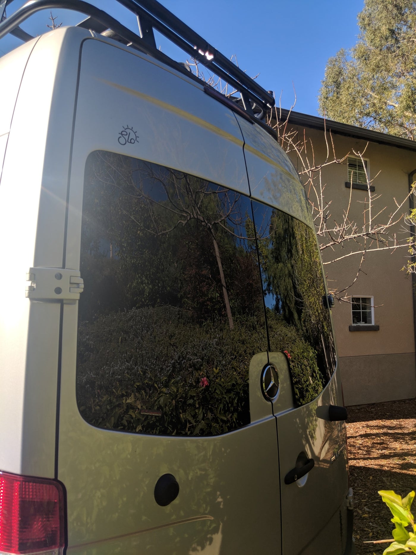 RV rental adventure awaits! Rear view of a silver Mercedes-Benz Sprinter van, equipped with a roof rack & reflective windows. — photo 34