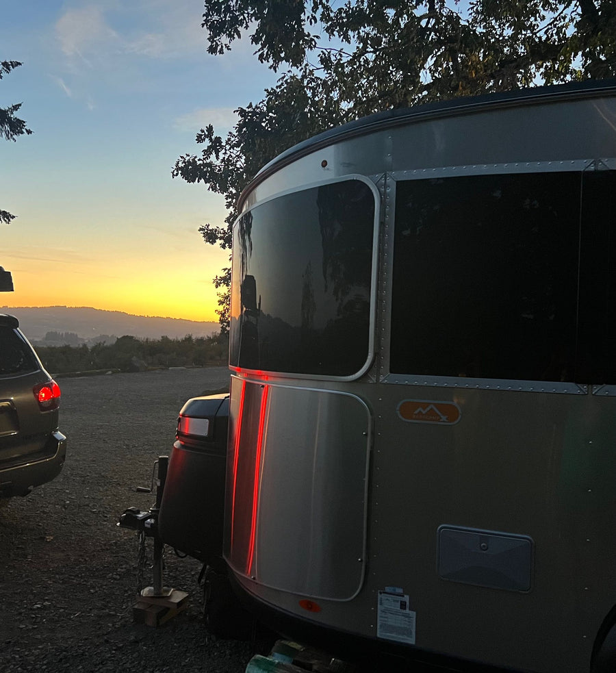  and a rear door with storage nets. Perfect for travel.|Compact RV rental interior featuring a kitchen with sink