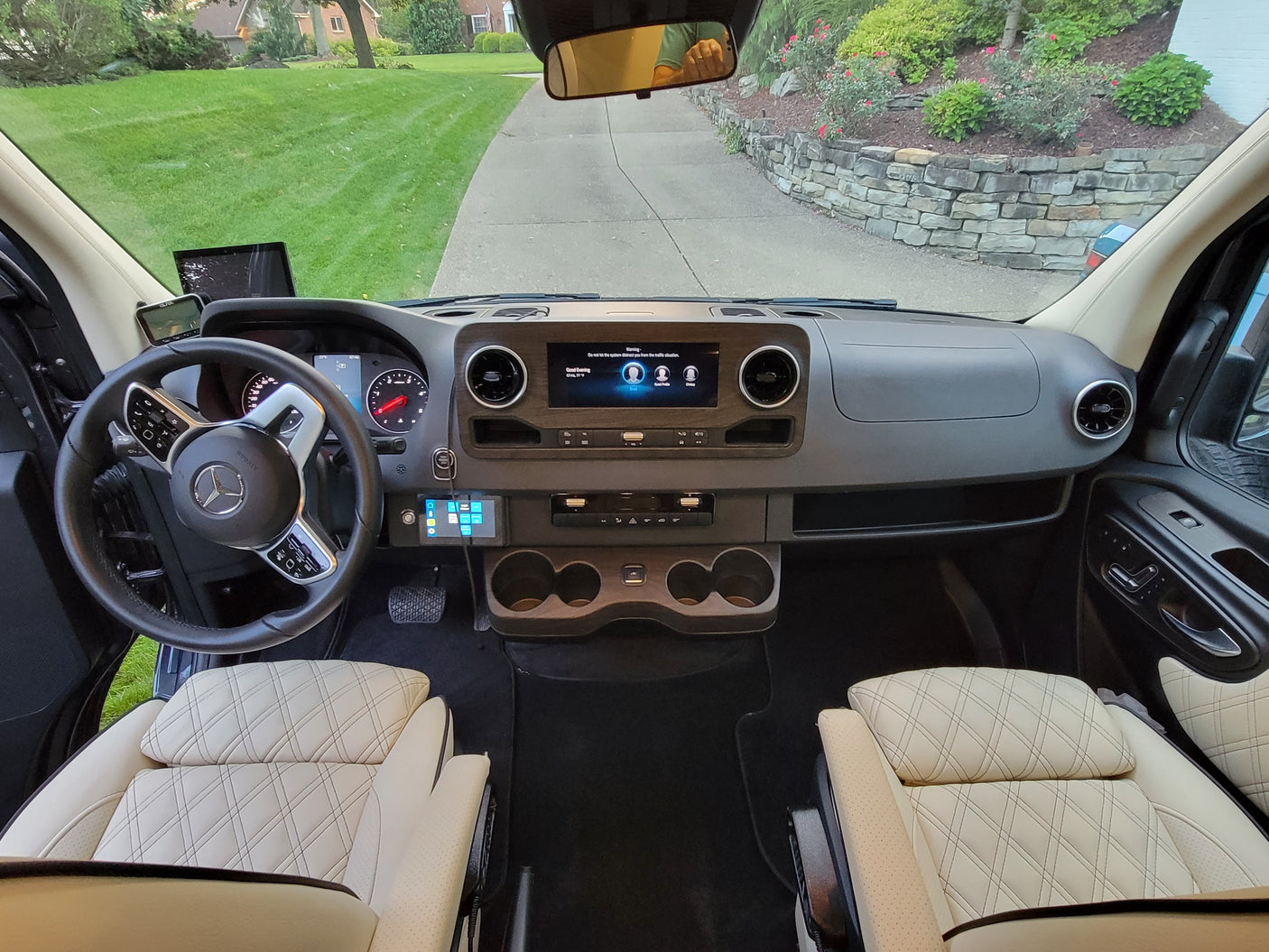 Spacious Mercedes-Benz rv rental cockpit, featuring a modern dashboard, steering wheel, and comfortable quilted seats.