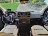 Spacious Mercedes-Benz rv rental cockpit, featuring a modern dashboard, steering wheel, and comfortable quilted seats.