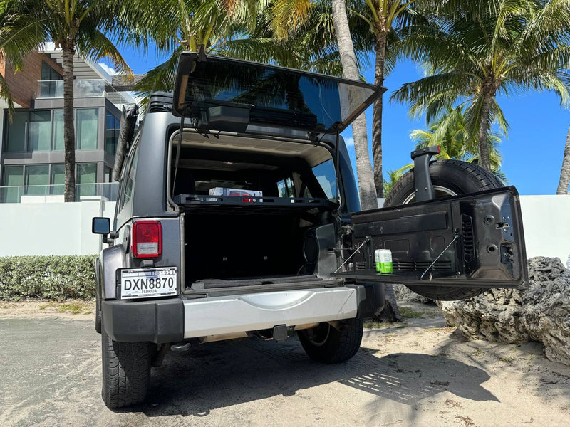 Adventure-ready Jeep, like an rv rental, with open trunk under palm trees, perfect for Florida travel & outdoor exploration. — photo 4