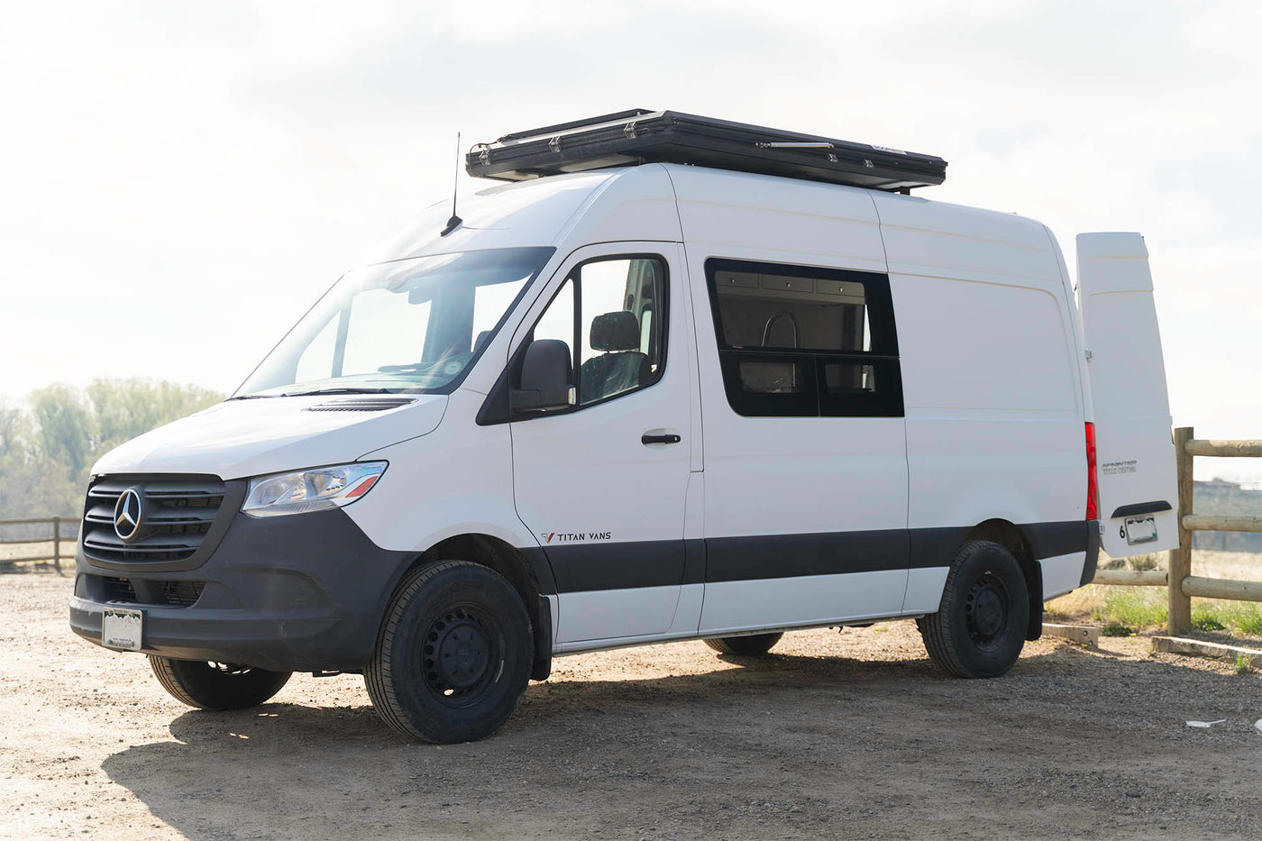  perfect for an RV rental adventure.|White RV rental van featuring a Roofnest roof tent and Max-Fan vent — photo 4