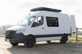 White Mercedes Sprinter camper van with a rooftop tent, perfect for an RV rental adventure.