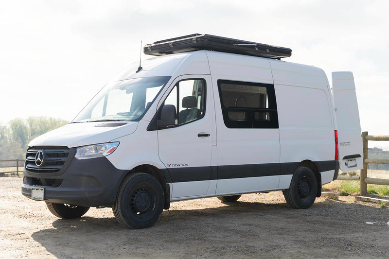  perfect for an RV rental adventure.|White RV rental van featuring a Roofnest roof tent and Max-Fan vent — photo 4