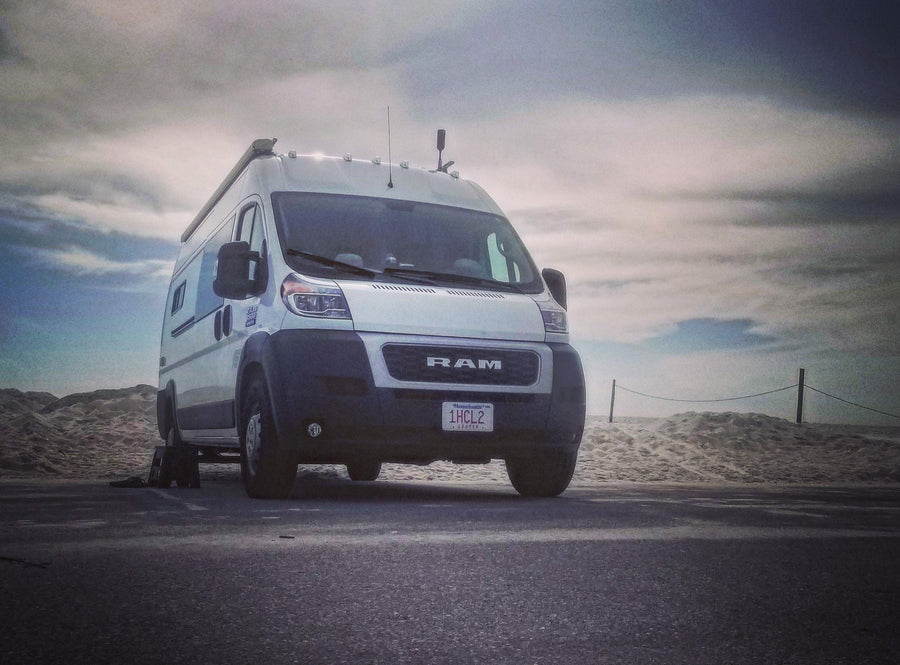  and warm ambient lighting.|This inviting RV rental camper van interior features blue upholstered seating