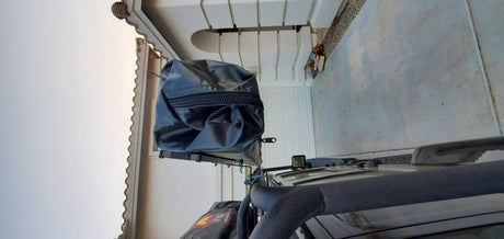 Overhead shot: black SUV with a roof-mounted camping tent in its travel cover, ready for your RV rental adventure.