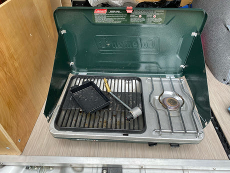 This Coleman propane grill stove is ready for outdoor cooking, ideal for an RV rental adventure.