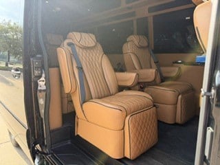  perfect for travel.|Step into your **RV rental**! This camper van's front cabin features tan captain's chairs — photo 19