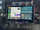 Dashboard of an RV rental with an Alpine infotainment system showing split-screen navigation and music.