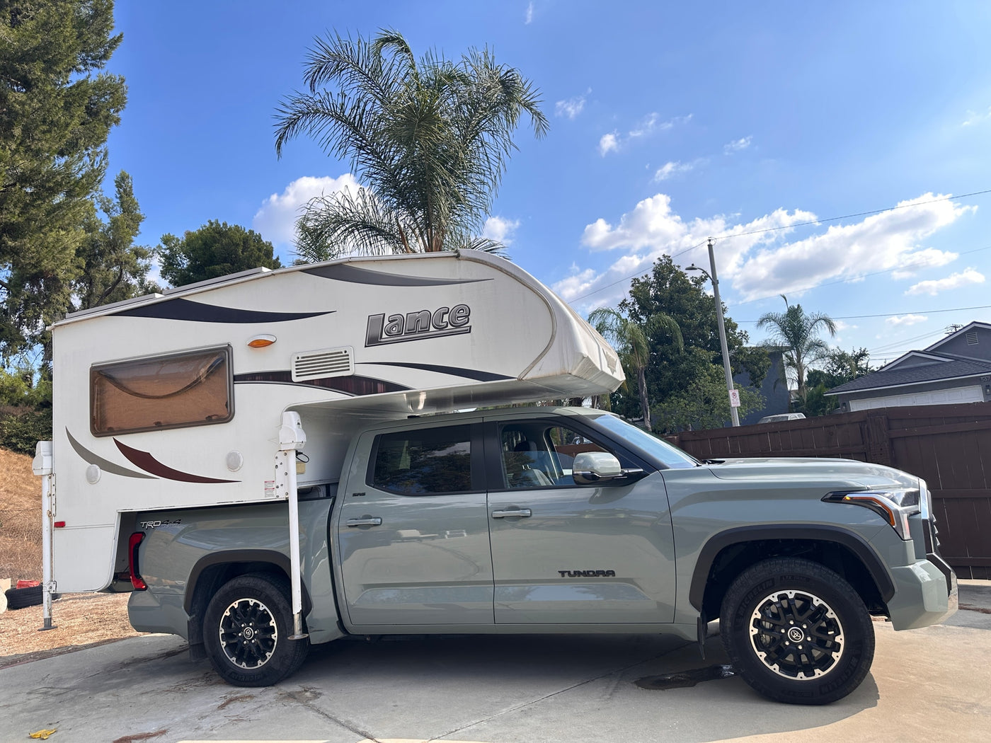  ready for your RV rental adventure.|Light grey Toyota Tundra pickup with a white Lance truck camper — photo 2
