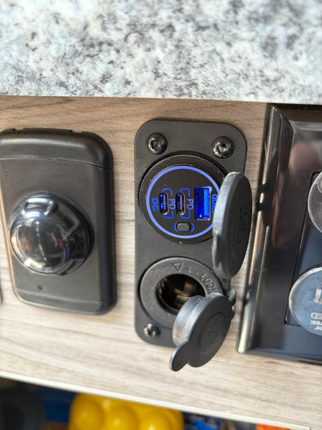 RV rental's convenient charging station: dual USB-C PD, USB-A QC3.0, and 12V socket, ready to power your devices.
