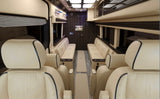 Spacious luxury RV rental van interior: plush cream seating, TV, and elegant amenities for premium travel.