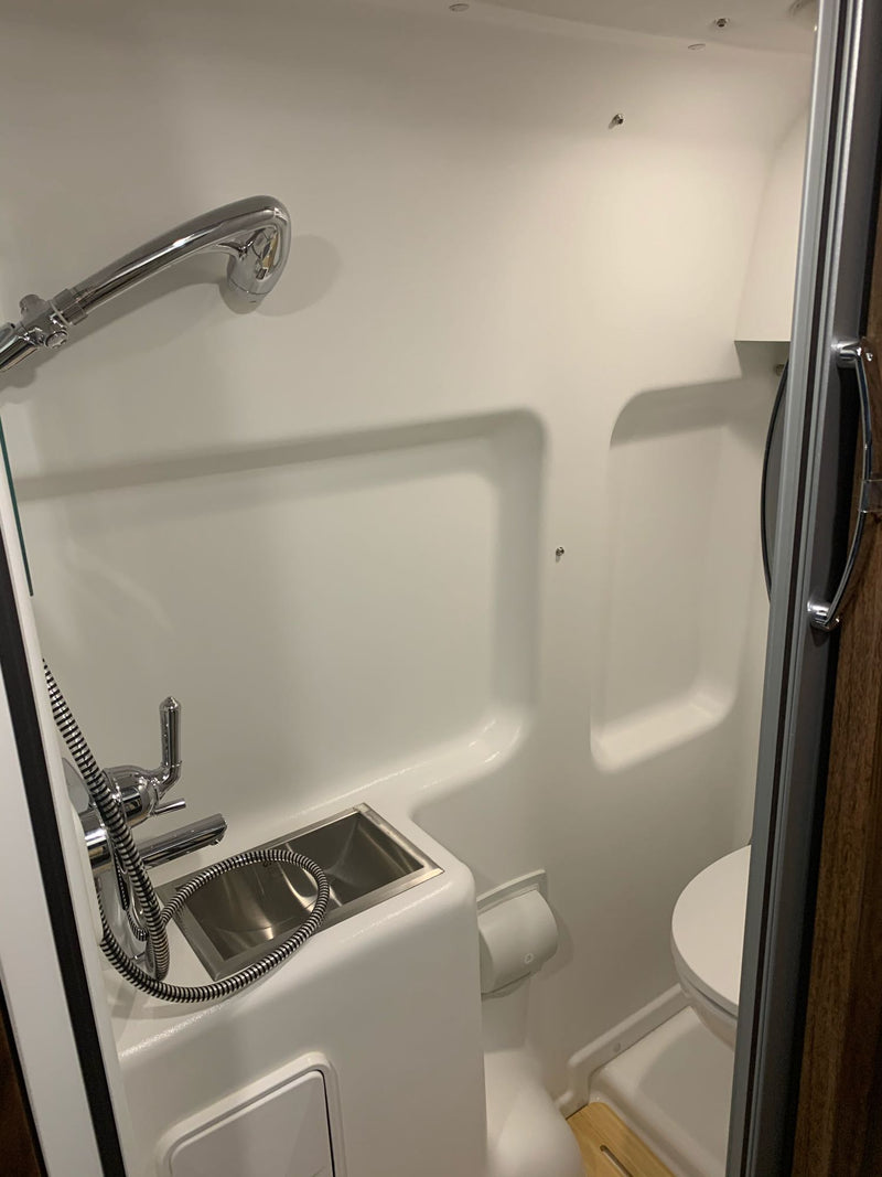  and smart storage for road adventures.|View into a well-appointed camper van's interior through its open rear doors — photo 10