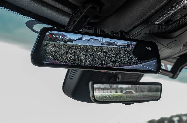 Dual rearview mirrors, including a digital display dash cam, inside an RV rental for enhanced visibility and safety. — photo 7
