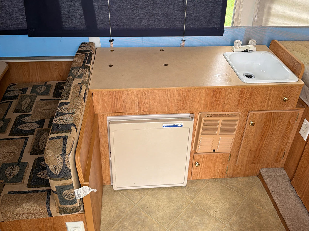  compact camping solution.|Interior of an RV rental pop-up camper showing dinette — photo 5