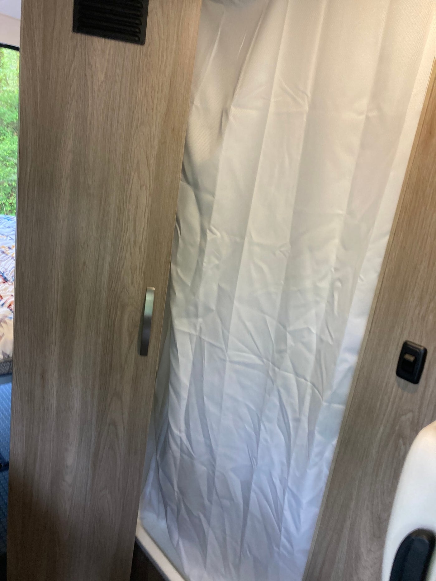  side door open to interior with wine setup. Great for your next rv rental adventure.|Step into this RV rental's cozy interior: dining table with wine — photo 17