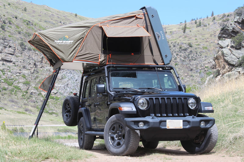 Black Jeep Wrangler with deployed Tuff Stuff Overland rooftop tent in mountains, a perfect mobile overlanding solution or unique RV rental alternative. — photo 10