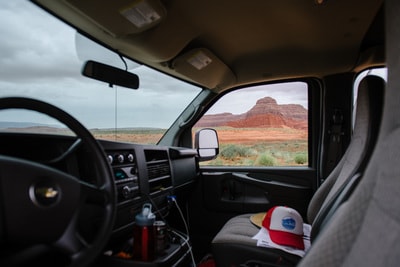 Van interior of an RV rental, showcasing vast desert and majestic red rock formations outside. Adventure awaits! — photo 2