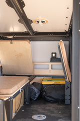 Efficient RV rental interior with modular beds, storage, and custom setup for adventure travel.