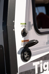 This RV rental displays its specialized solar input and standard 30-amp shore power inlet for versatile energy options.