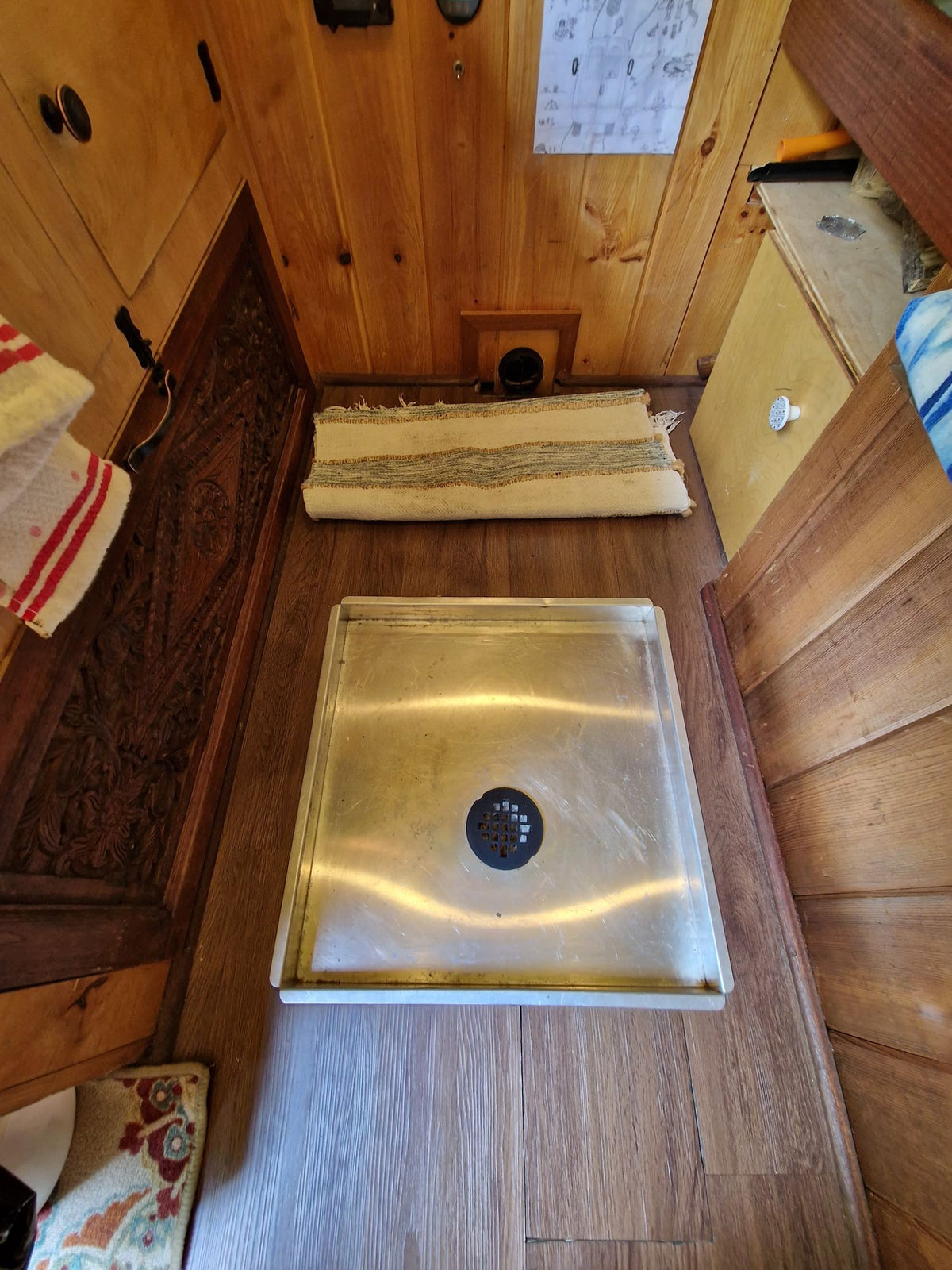  and outdoor view of a sunny green yard. Ideal for travel & adventures.|Inside an RV rental: A compact kitchen area featuring a two-burner stove — photo 14