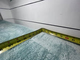 Yellow tape measure on a fuzzy blue blanket in an RV corner, showing 67-81 inches. Essential for rv rental space planning.
