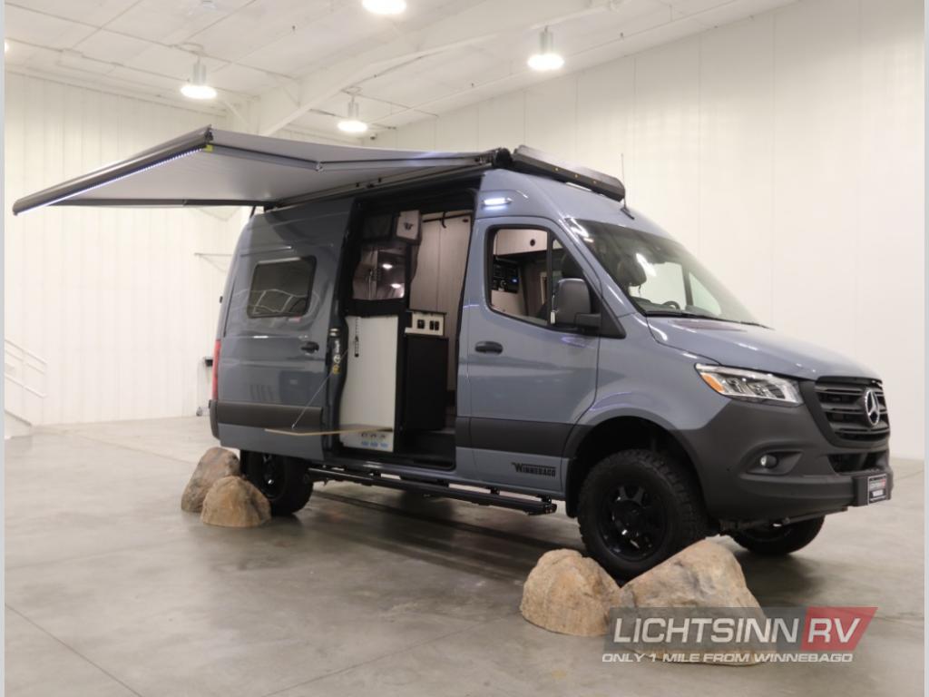  blending indoor comfort with outdoor views.|View inside a grey rv rental van from the rear. Open doors show a raised bed — photo 2