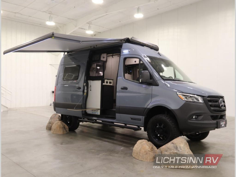 blending indoor comfort with outdoor views.|View inside a grey rv rental van from the rear. Open doors show a raised bed — photo 2