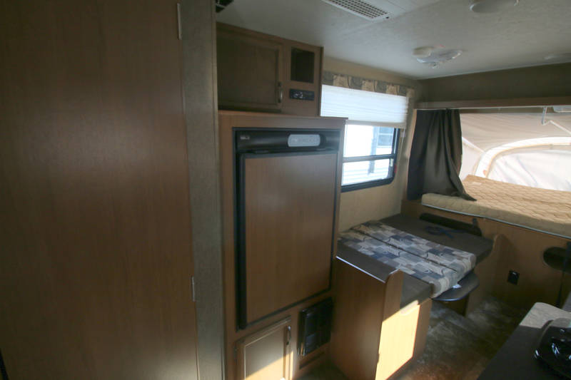  flanked by wood cabinets.|RV rental: Interior showing wooden overhead cabinets — photo 4