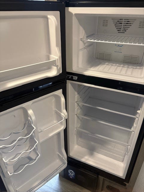  and 56" dinette.|Inside a modern RV rental: a compact kitchen