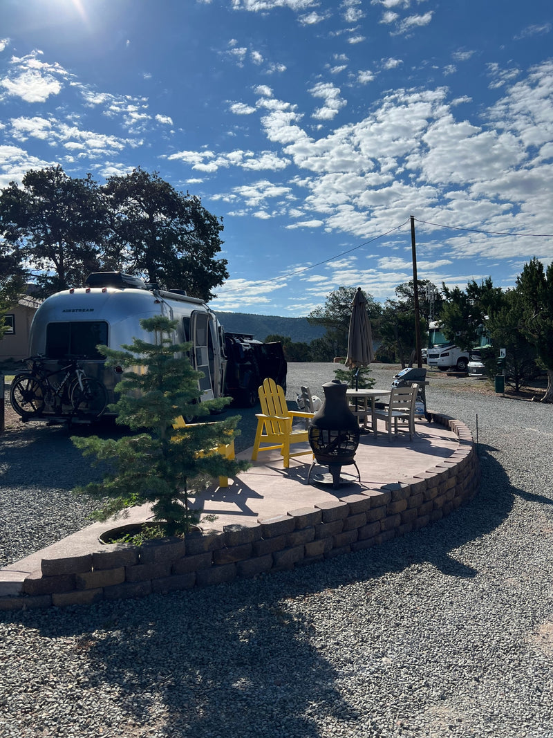 Your RV rental adventure begins here! A gleaming Airstream and bikes with a comfortable patio, chairs, and fire pit. — photo 7