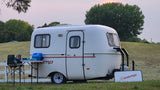 Scamp trailer ready for your next rv rental adventure, with outdoor cooking setup at sunset.