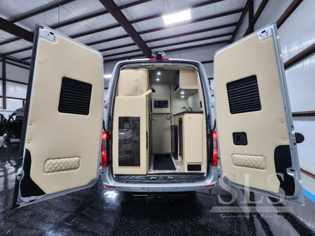 Explore this luxury RV rental! Custom camper van interior with a kitchenette and cozy setup for travel.