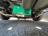 Underside view of an RV rental showing an Onan Cummins QG 2800i generator, chassis, and tires.