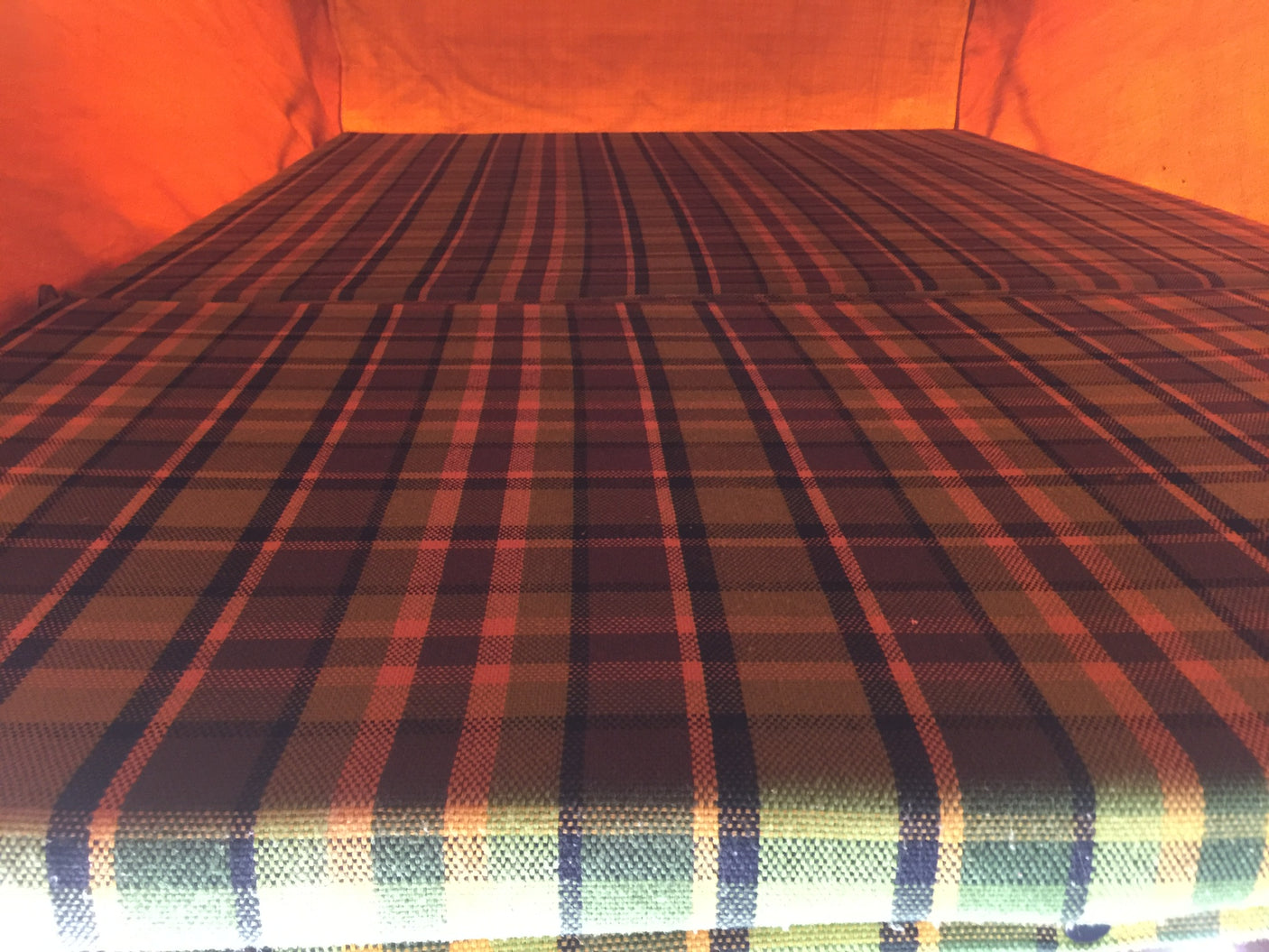 Cozy plaid bed inside an RV rental. Perfect for camping and road trips.