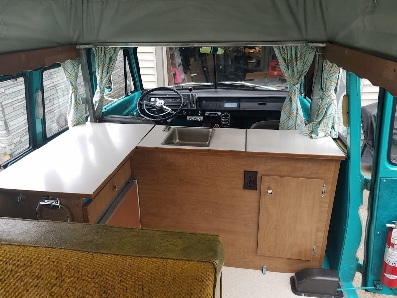  and custom wood cabinets.|Step inside this vintage VW RV rental! A charming camper interior with yellow-gold benches — photo 12