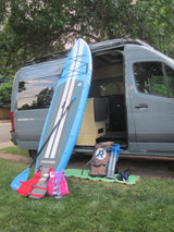 Rossmonster RV rental with iRocker paddleboard, paddle, pump, and life vests. Ready for water adventures and van life.
