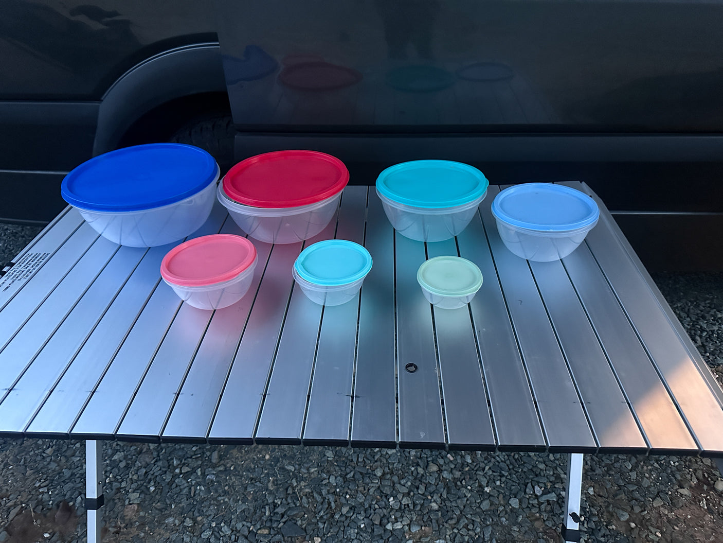 Colorful food storage containers on a portable table, ready for an RV rental adventure.