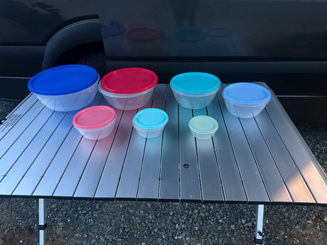 Colorful food storage containers on a portable table, ready for an RV rental adventure.