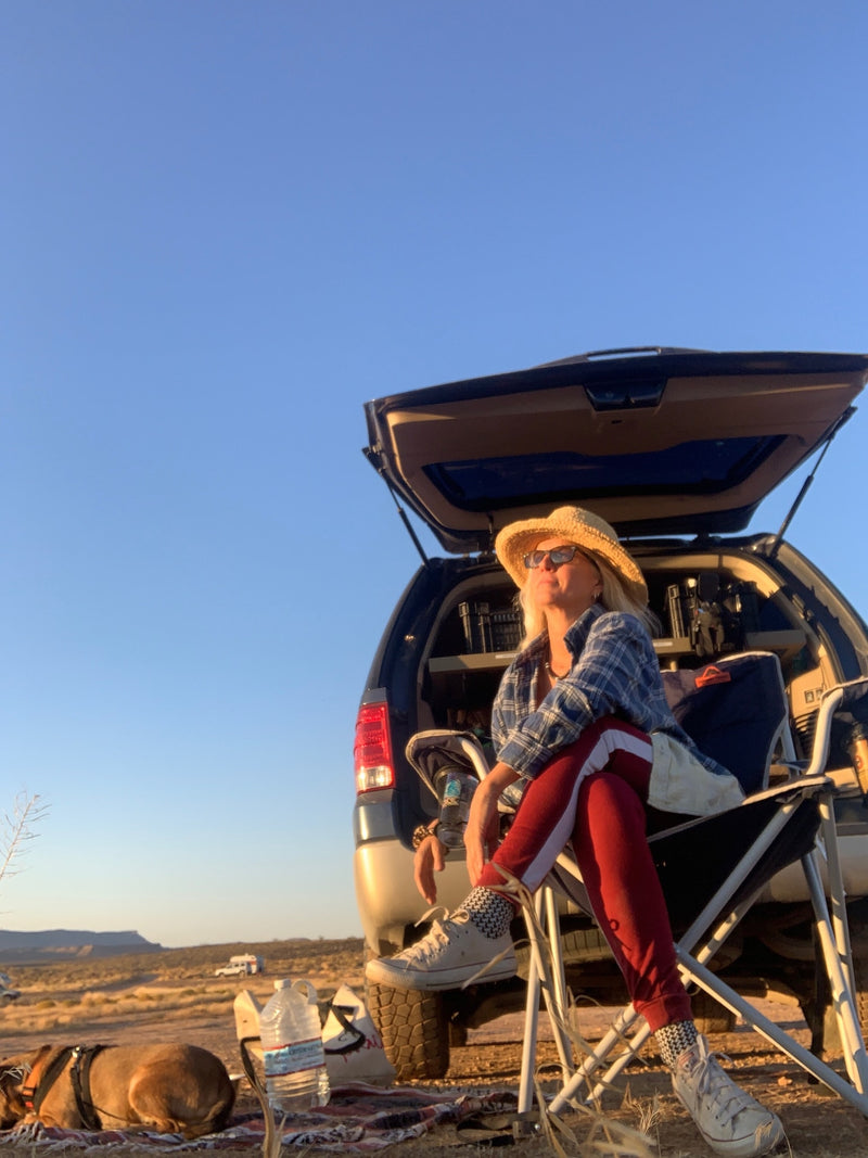  a great rv rental alternative for road trips.|Woman with dog unwinds by SUV — photo 2