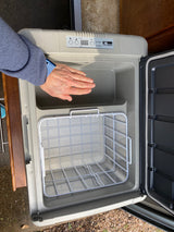 Inside a spacious Norcold portable fridge-freezer, ready for your next RV rental trip.