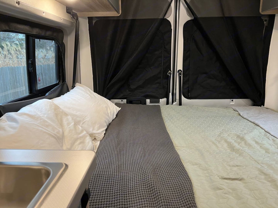  and pop-top access.|Cozy night by the campfire with an RV rental. Perfect outdoor escape under the stars.|Cozy RV rental interior features a made bed