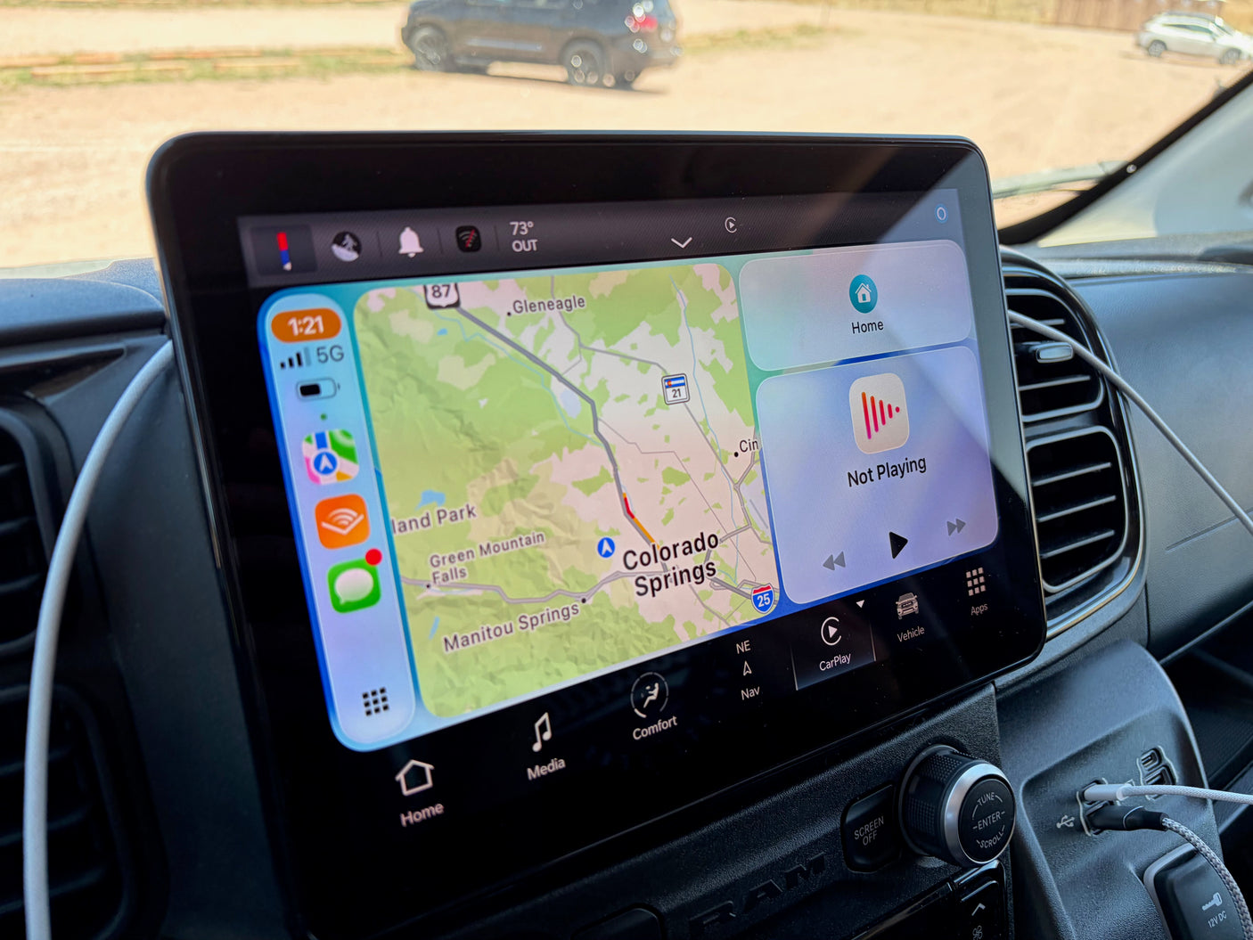 Apple CarPlay on an RV rental dash shows a map of Colorado Springs, 'Not Playing' music, 73°F, and 1:21 time.