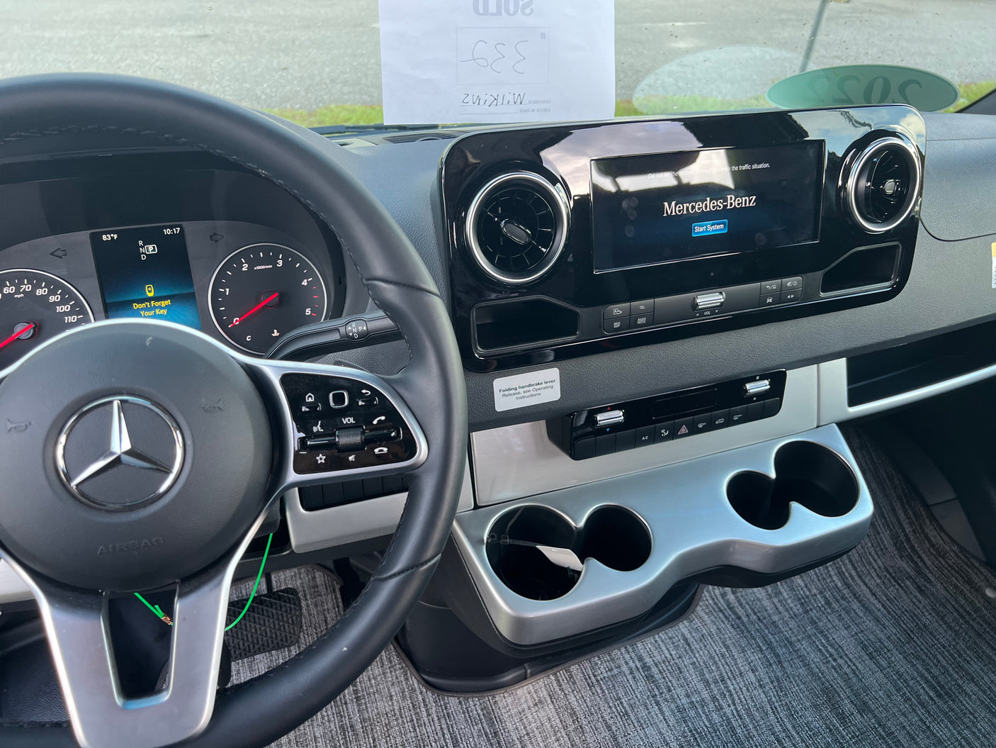 Inside a Mercedes-Benz RV rental, showing the dashboard with steering wheel, instrument cluster, and central infotainment screen.