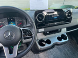 Inside a Mercedes-Benz RV rental, showing the dashboard with steering wheel, instrument cluster, and central infotainment screen.