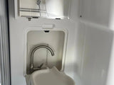 RV rental's compact wet bath features an integrated sink, faucet, and overhead shower.