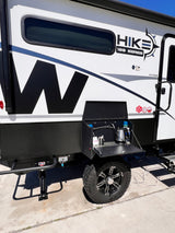 This Hike 100 Series rv rental is a rugged travel trailer, featuring an exterior kitchen setup and off-road tires.