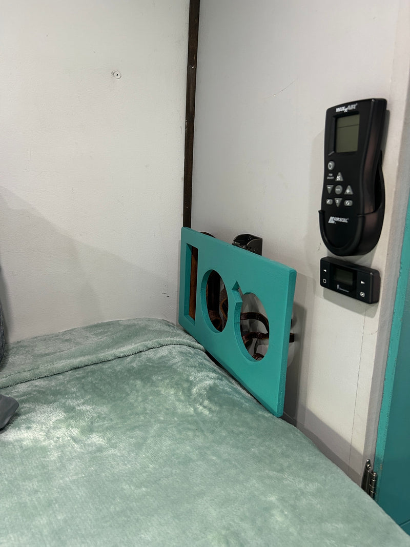  & a rock heart on the ground.|RV rental: Solar-powered van by the ocean with a pier in the distance. Perfect for off-grid beach adventures!|RV rental: Inside a camper van's front cabin. Features teal seats — photo 6