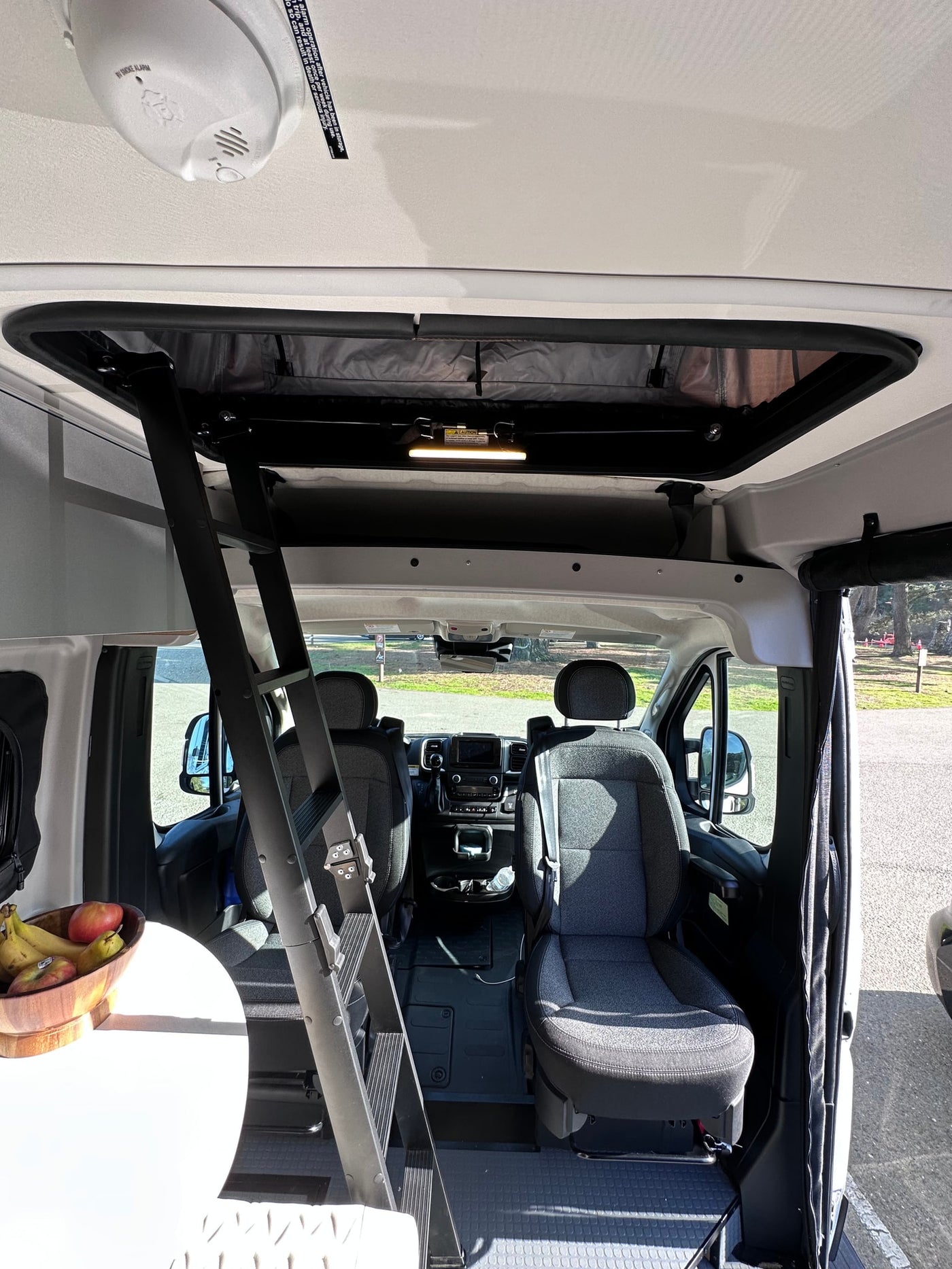  stocked with drinks and snacks for your adventure. Ideal for travel needs.|RV rental interior: A compact kitchen with sink and fresh fruit — photo 18